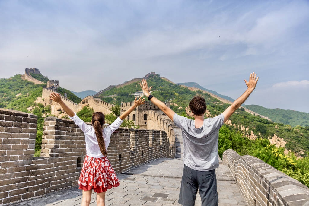 Travelers enjoying the Great Wall of China, iconic landmark and unforgettable travel experience