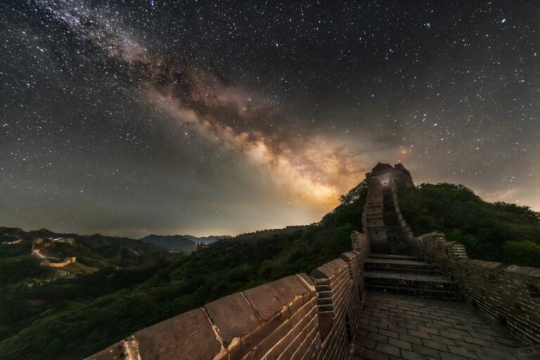 The Great Wall under a bright Milky Way and starry night sky.