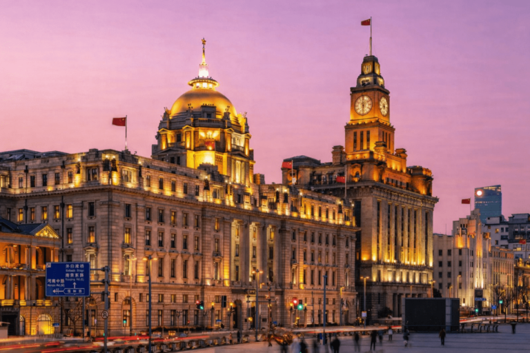 Historic Bund buildings illuminated at night in Shanghai.