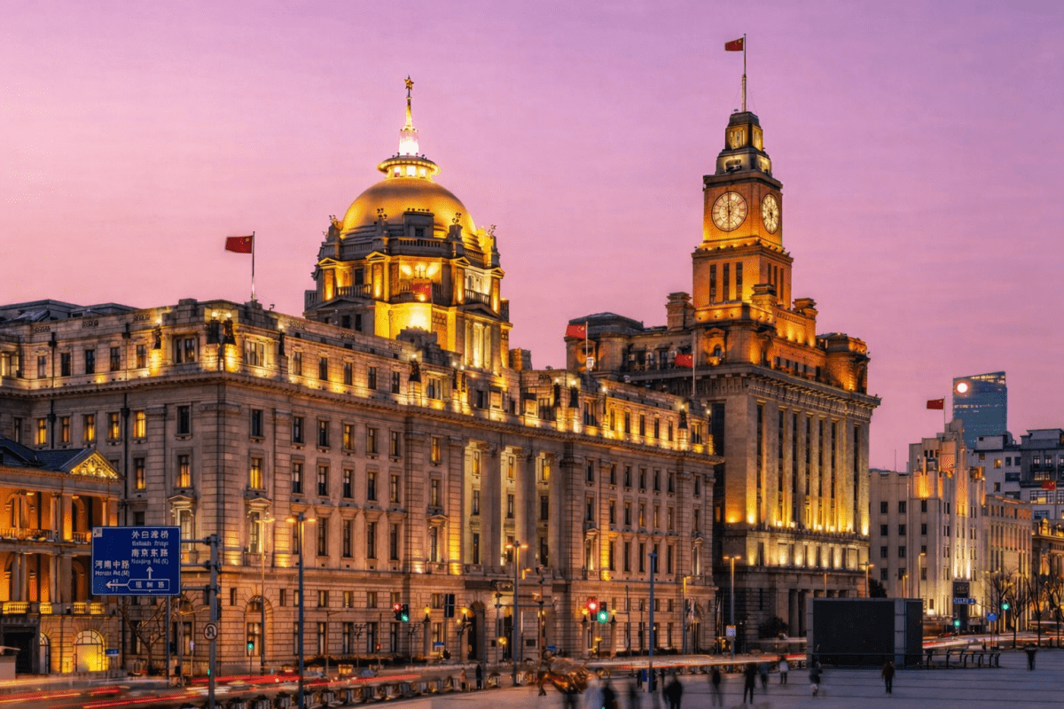 Historic Bund buildings illuminated at night in Shanghai.