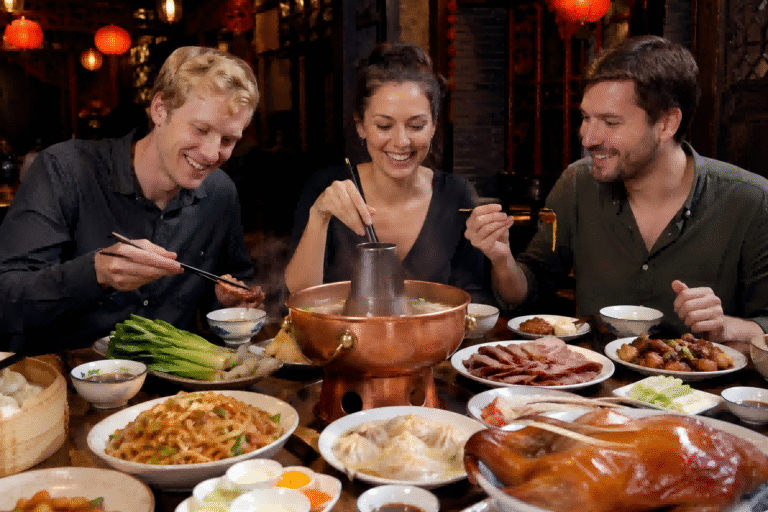 Friends enjoying Chinese hot pot and traditional dishes