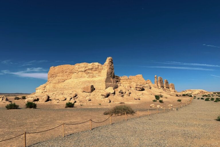 Ancient mud ruins in arid desert under blue sky