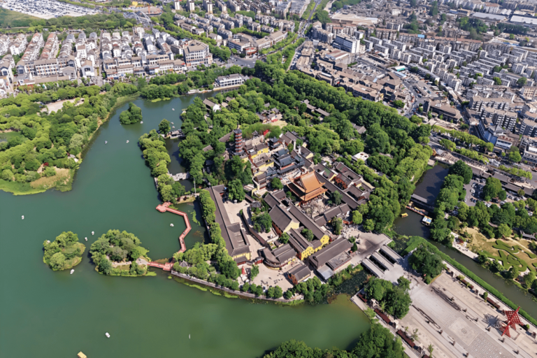 Scenic Chinese water town with temples, lake, and urban skyline