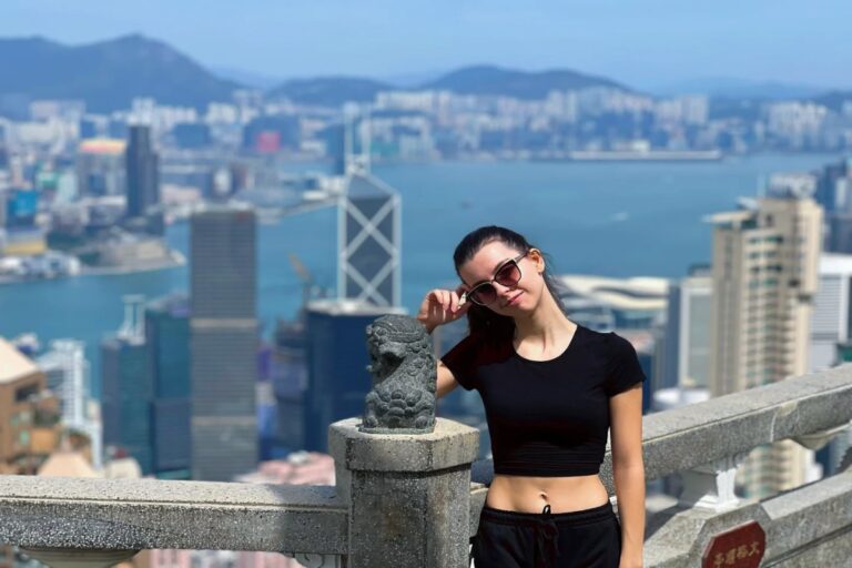 Woman at Victoria Peak overlooking Hong Kong skyline