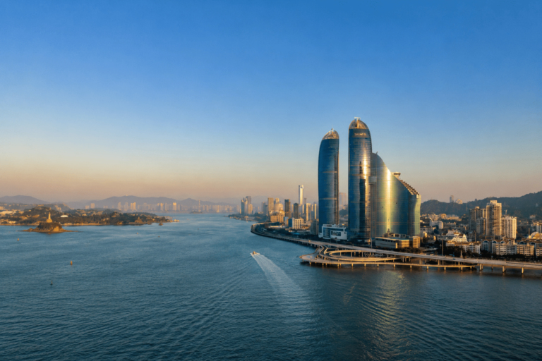 Sunset view of Xiamen skyline with modern skyscrapers and coastal scenery by the sea
