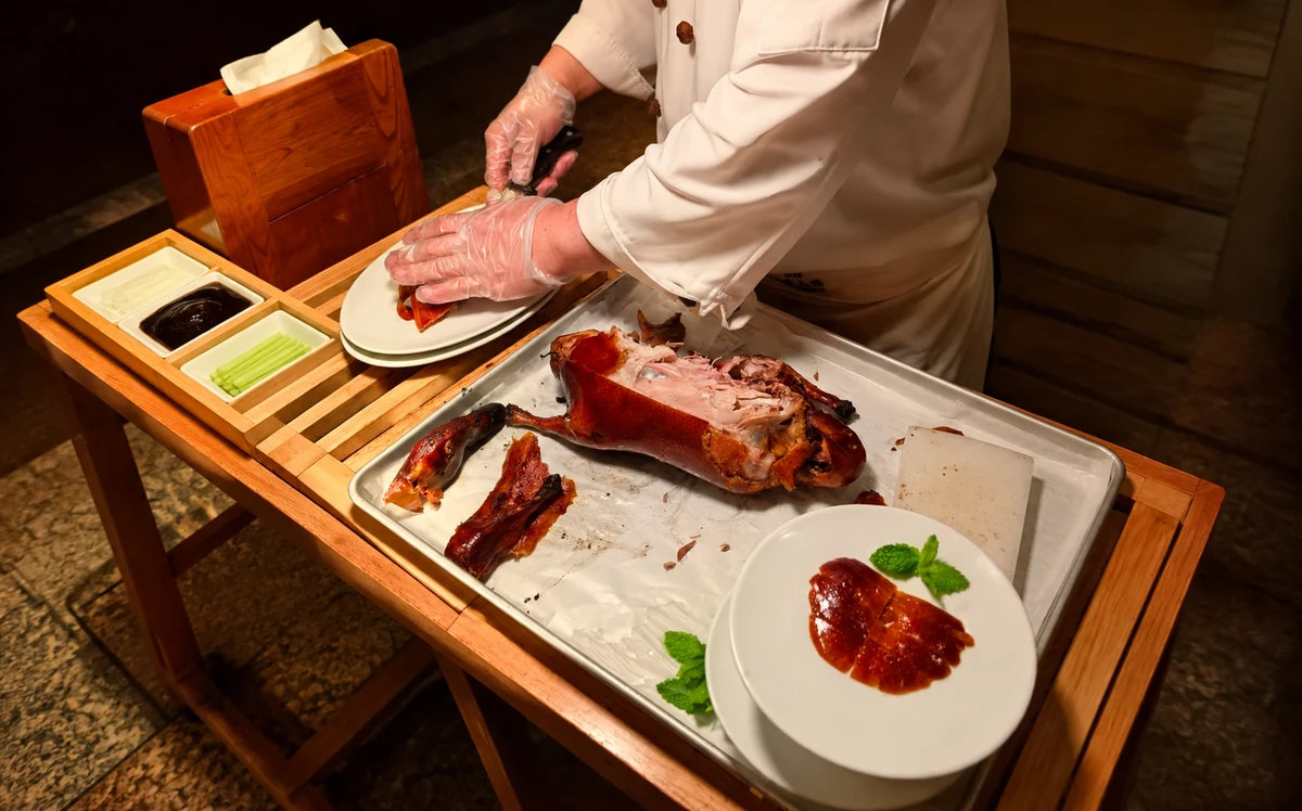 Chef carving Peking duck at a restaurant in Beijing
