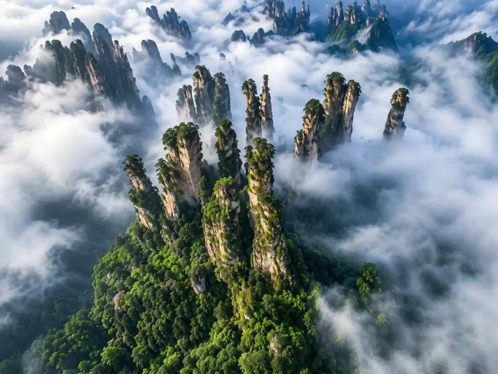 Aerial view of Zhangjiajie National Forest Park with towering sandstone pillars rising through the mist in Hunan, China
