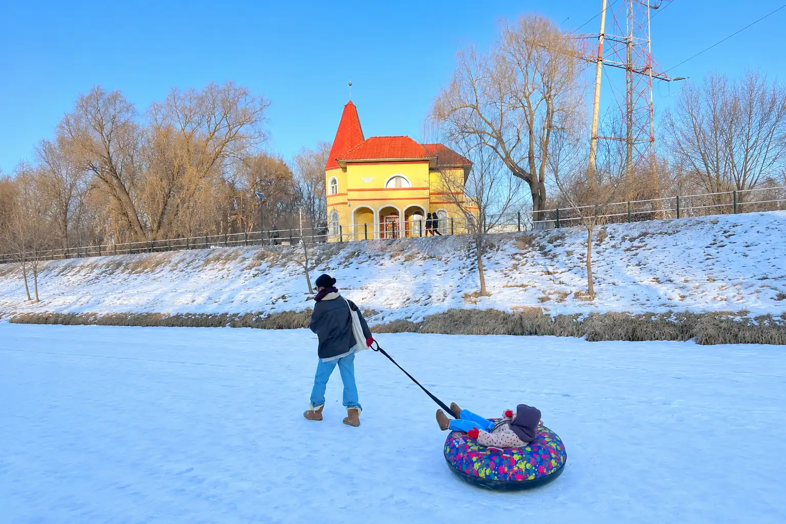 Family enjoying winter snow activities in Harbin