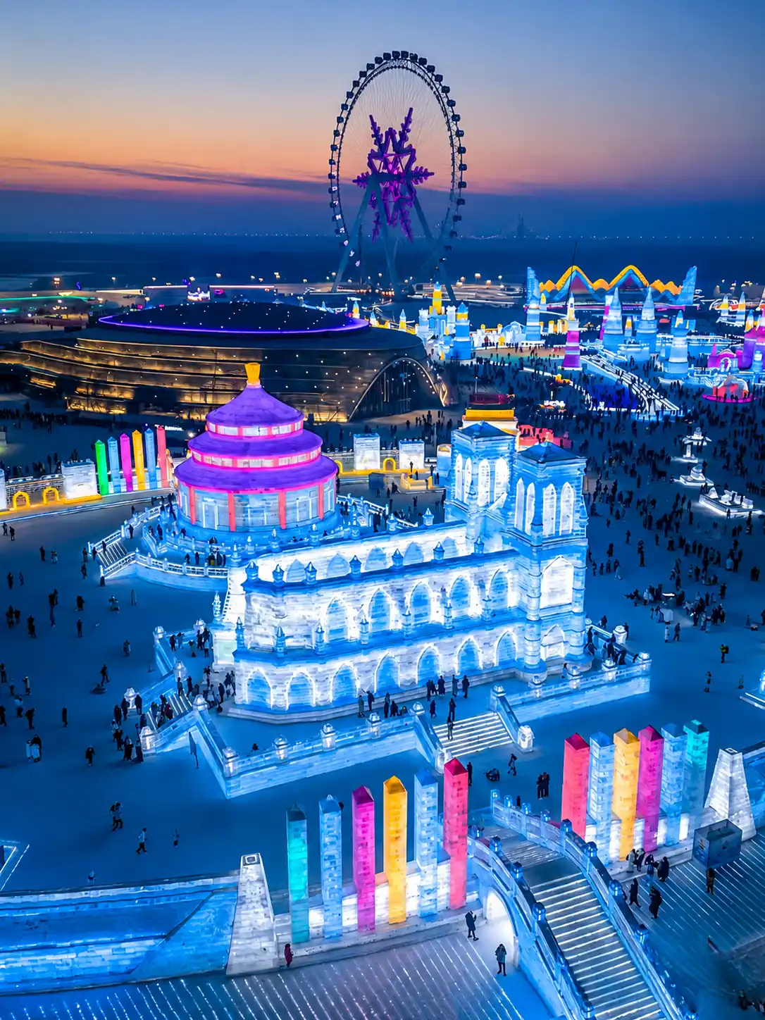 Illuminated ice buildings at Harbin Ice and Snow World in winter