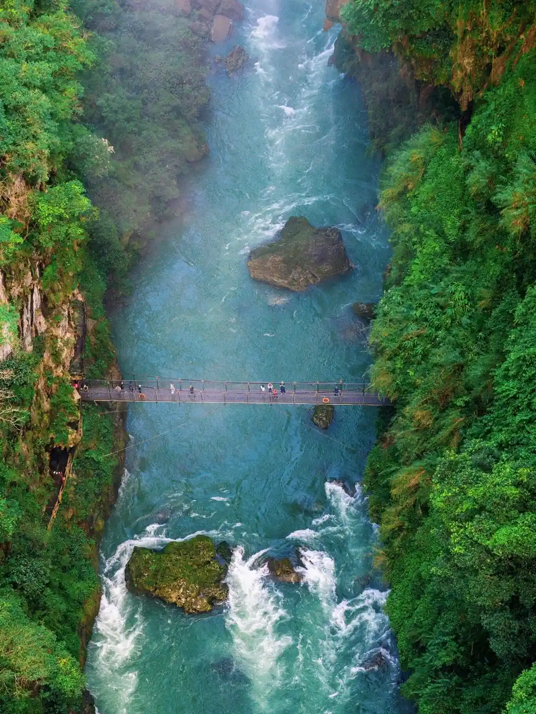Turquoise river gorge and suspension bridge in the Nu River region of western Yunnan