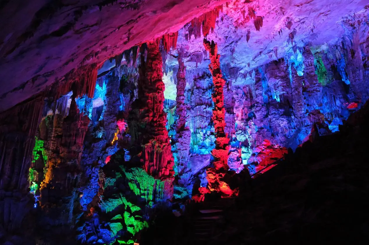 Illuminated limestone formations inside Reed Flute Cave in Guilin