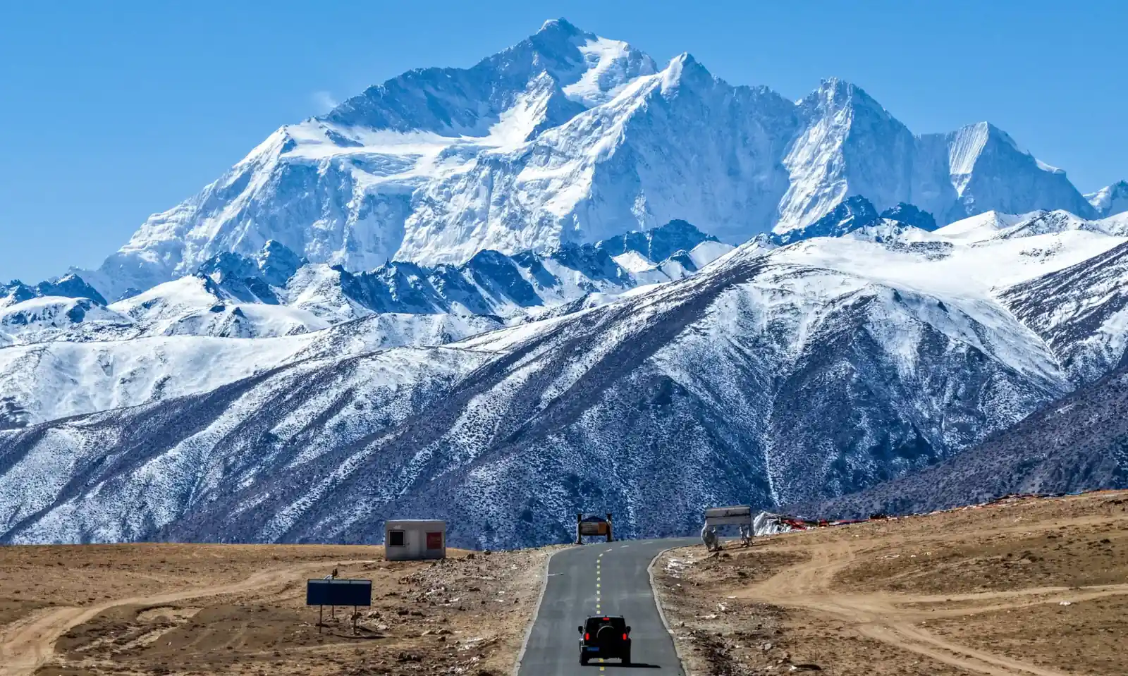 Road journey across the Tibetan Plateau with mountain scenery