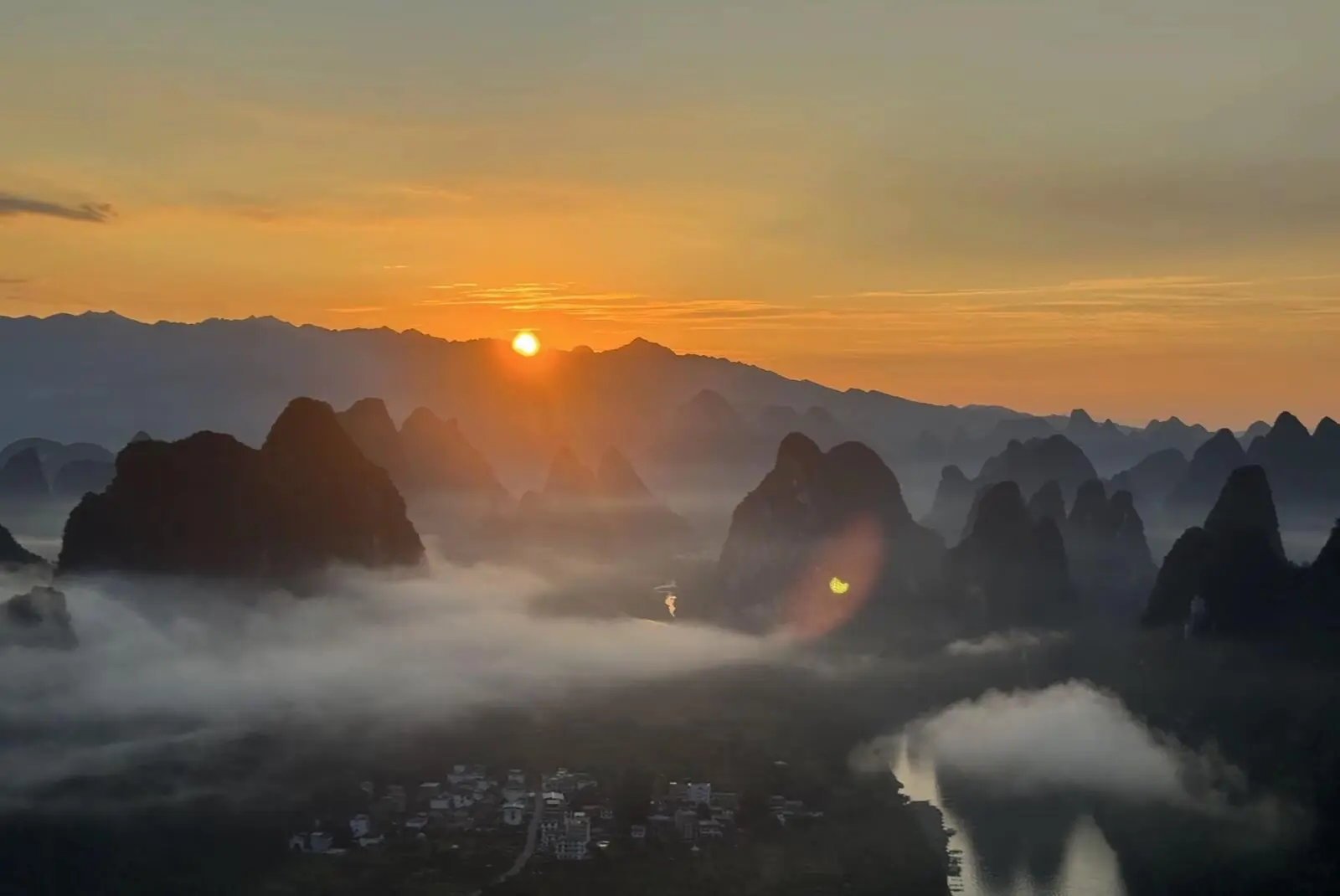 Sunrise over the Li River and karst peaks from Xianggong Mountain