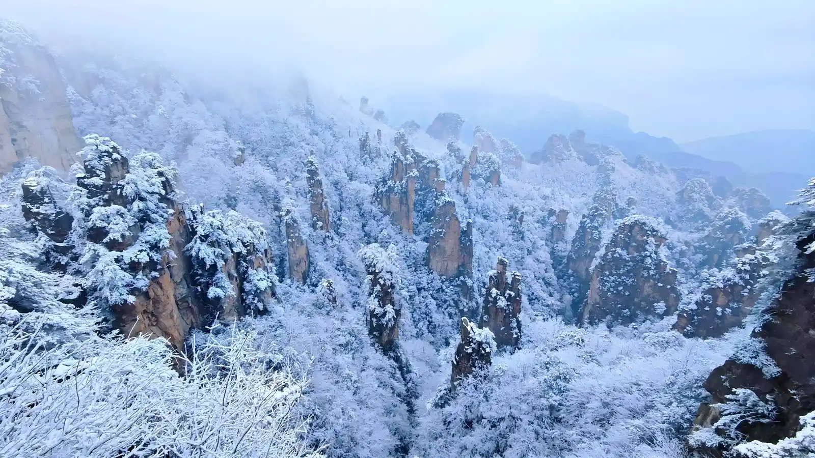 Snow-covered sandstone peaks in Zhangjiajie during winter