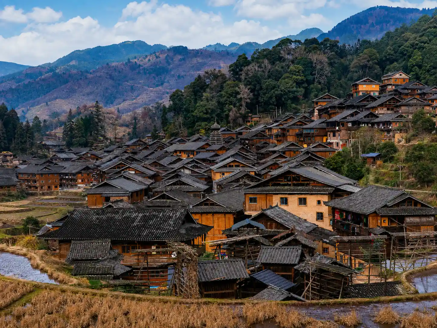 Zhanli Dong Village surrounded by mountains and rice fields in Guizhou