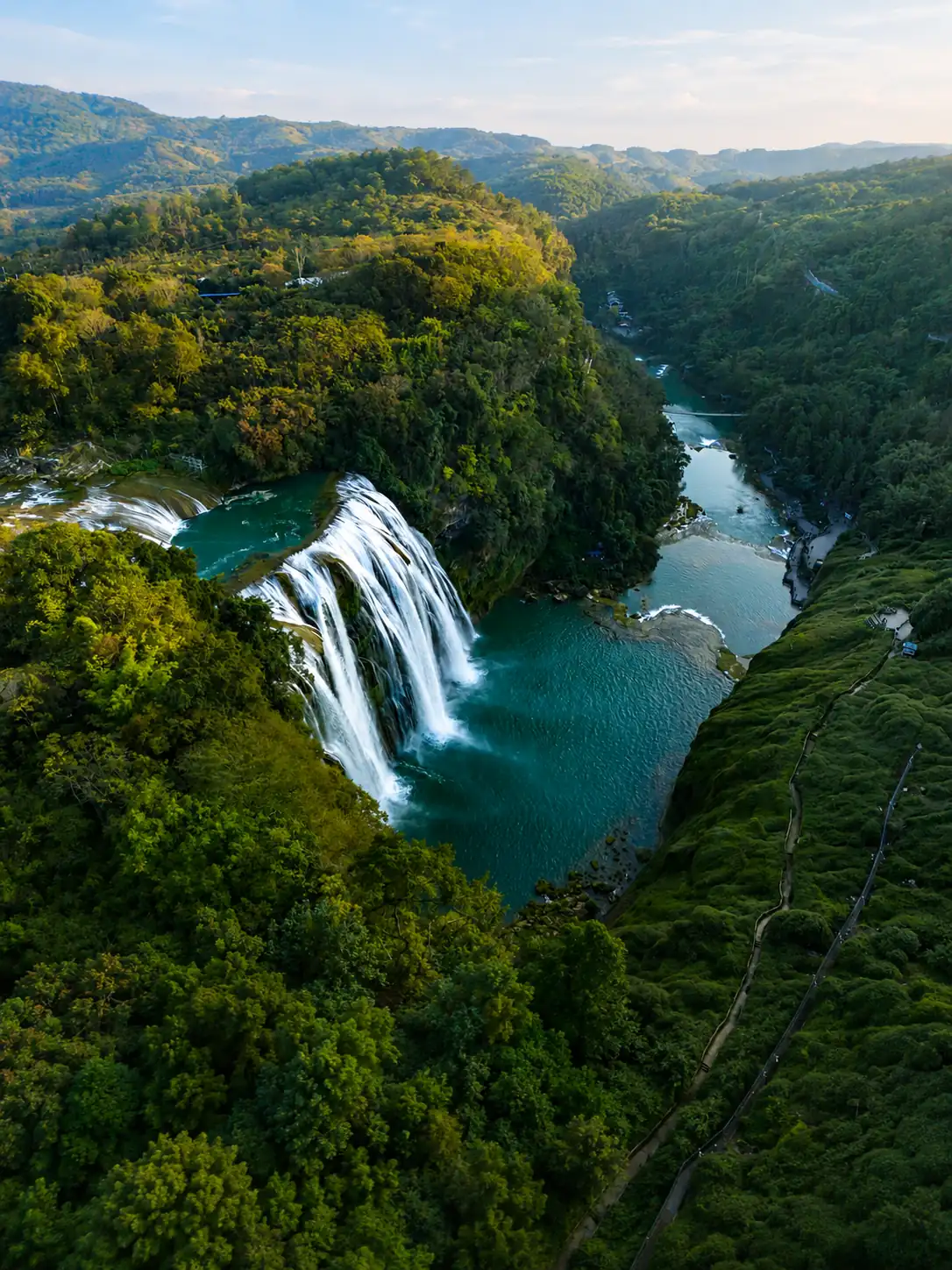 Waterfall and green valley landscape in Guizhou during summer