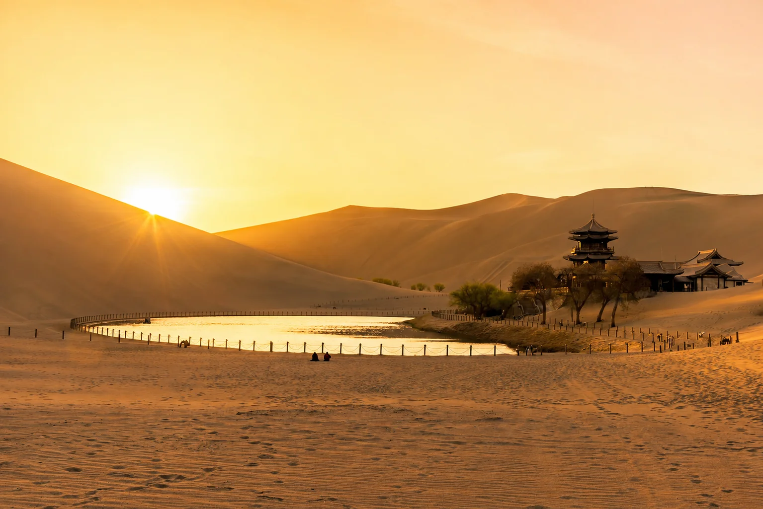 Echoing Sand Mountain and Crescent Moon Spring in Dunhuang at sunset