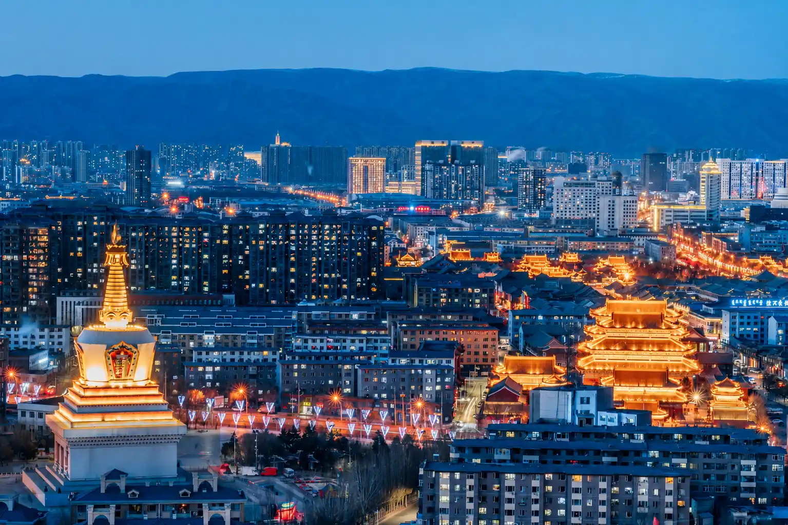Hohhot city skyline and mountains illuminated at night in Inner Mongolia