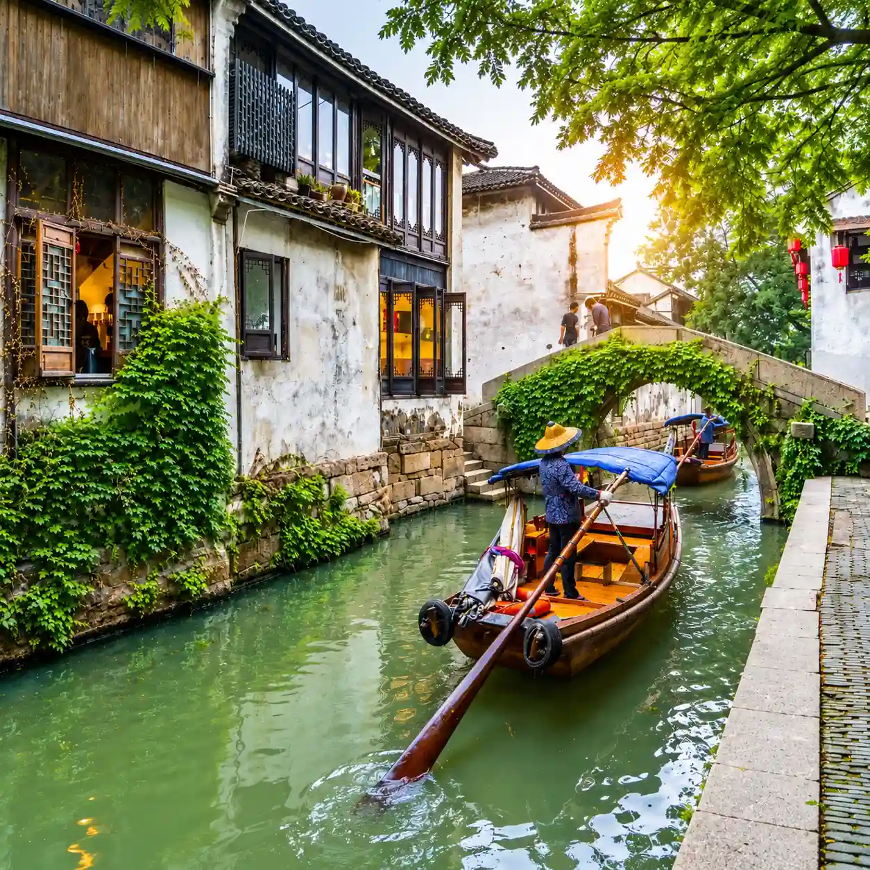 Traditional Boat Passing an Ivy-Covered Bridge in Suzhou