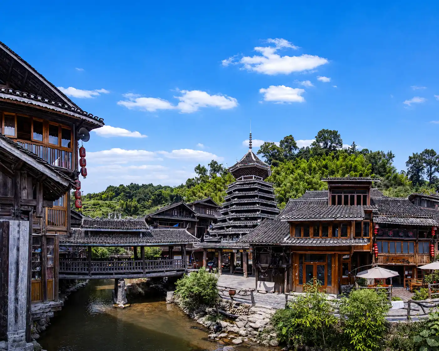 Traditional Dong village with a drum tower and stream in Guizhou